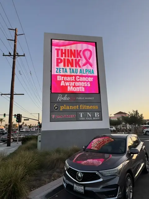 Zeta Tau Alpha Think Pink breast cancer awareness ad on a digital sign in Orange County